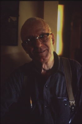 Portrait of the artist Clarence Swinyer, an older white man with glasses