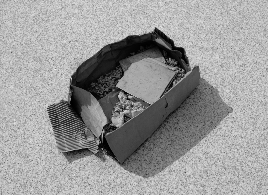 Barney Kulok black and white photograph of cardboard box with construction materials inside