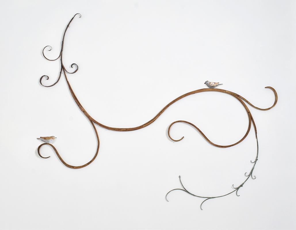 Mary Carlson wall sculpture of birds and curlicue