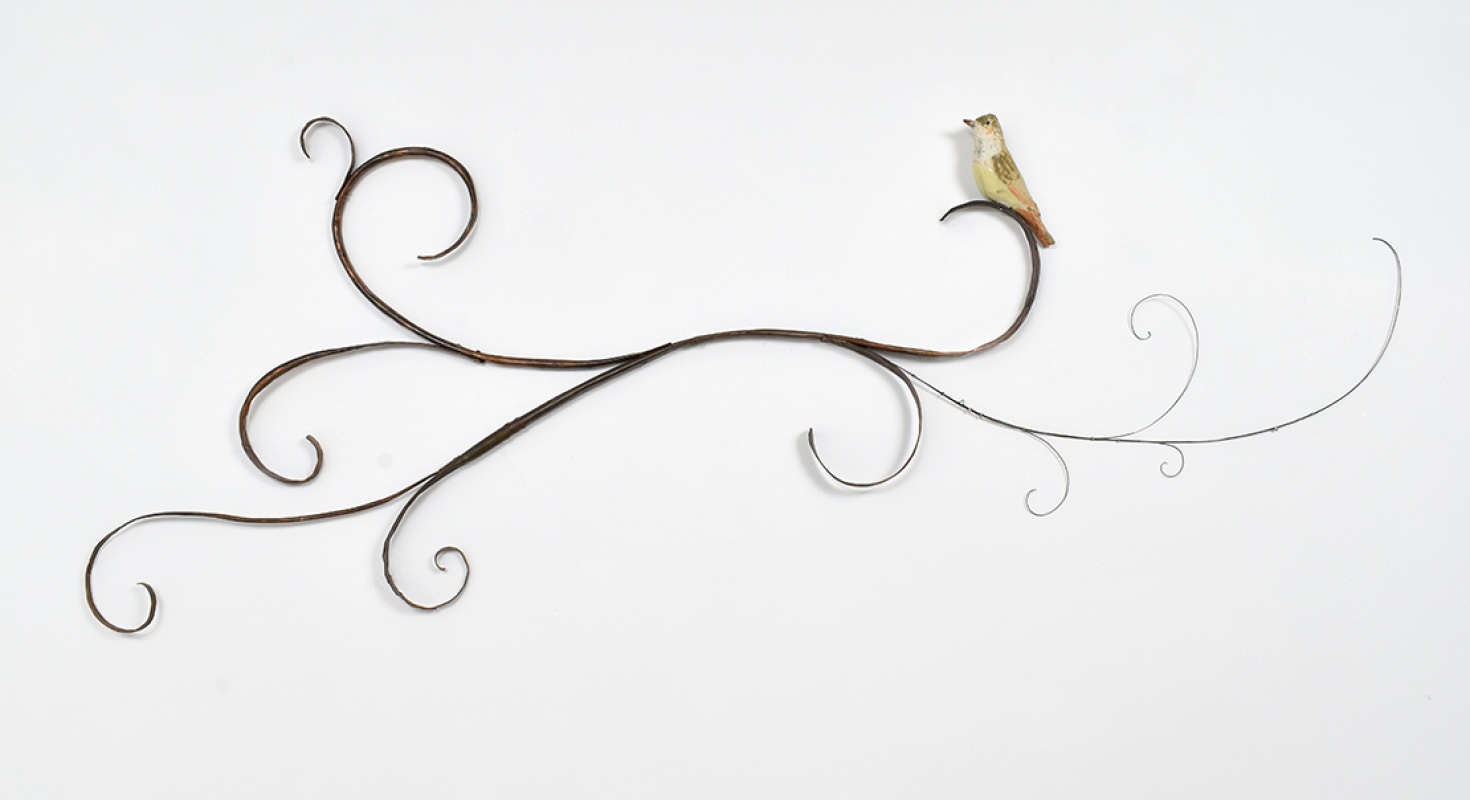 Mary Carlson sculpture of bird resting upon horizontal curling vines