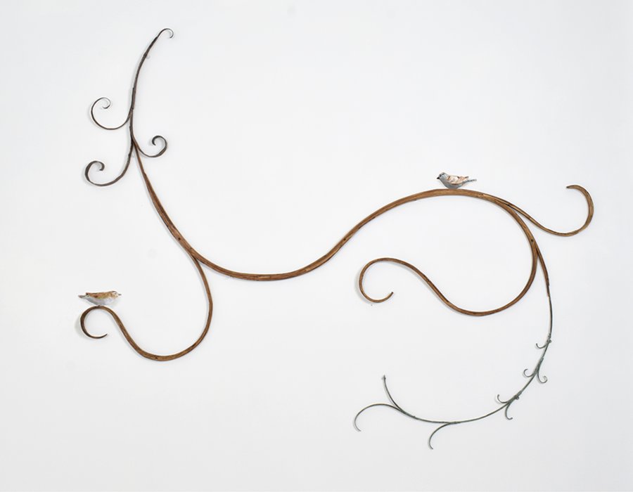 Mary Carlson wall sculpture of birds and curlicue