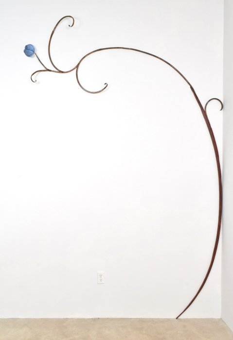 Mary Carlson wall sculpture of blue flower pod and large arching curlicue