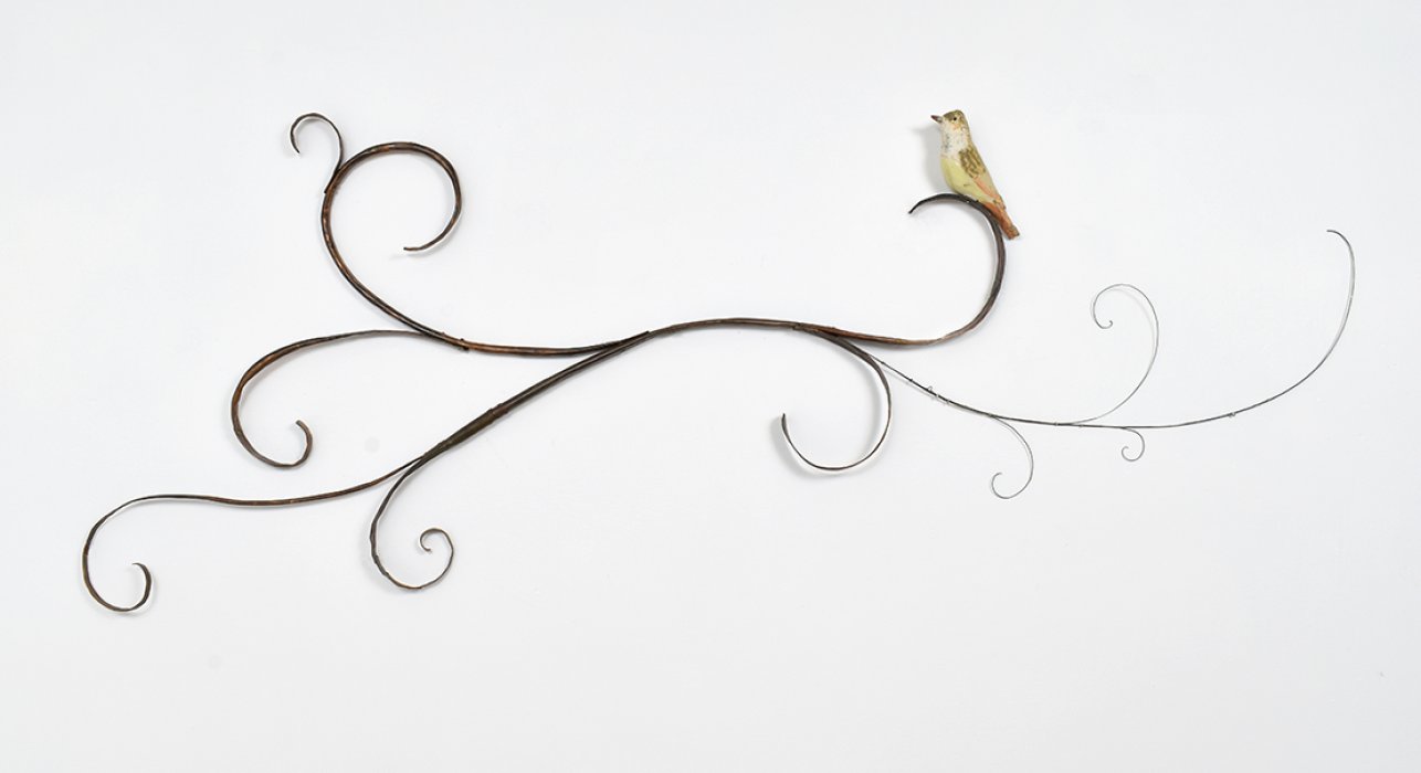Mary Carlson sculpture of bird resting upon horizontal curling vines